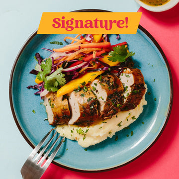 Signature: Jamaican Jerk Style Chicken with Spicy Citrus Jerk Sauce, Caribbean Slaw & Brown Rice & Black Beans