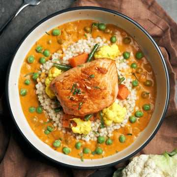 Seared Salmon with Sundried Tomato Cream Sauce, Roasted Vegetables & Pearl Couscous