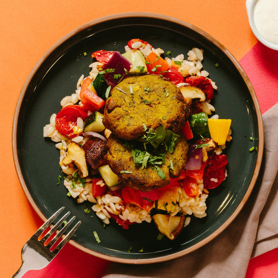 Chickpea & Spinach Fritters with Roasted Vegetables, Whipped Feta, Sundried Tomatoes & Lemon Orzo